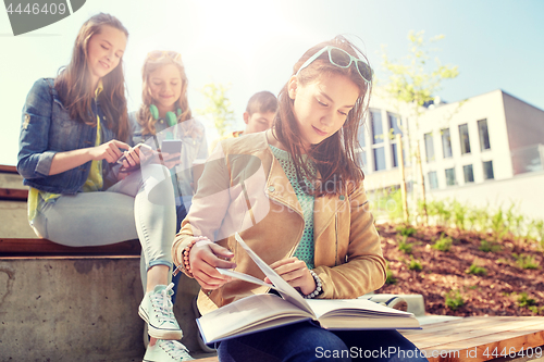 Image of high school student girl reading book outdoors