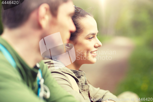 Image of smiling couple with backpacks in nature