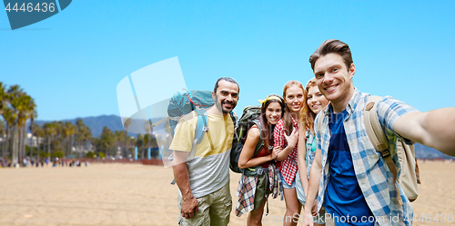 Image of friends with backpacks taking selfie