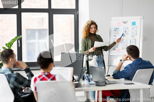 Image of creative woman showing user interface at office