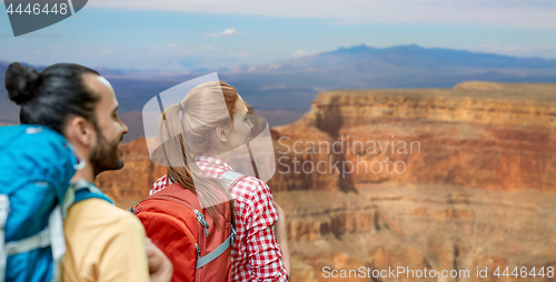 Image of couple with backpacks over grand canyon