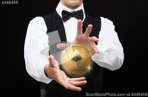 Image of close up of magician with ethereum coin