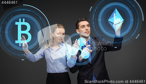 Image of businesspeople with cryptocurrency holograms