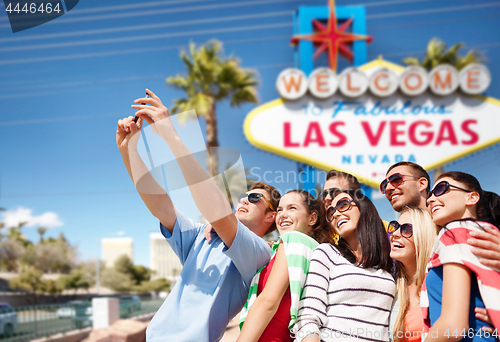 Image of group of happy friends taking selfie by cell phone