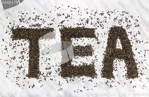 Image of The word TEA written with Gunpowder green tea leaves