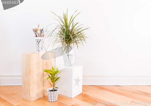 Image of Paintbrushes and houseplants in hand-painted ceramic pots