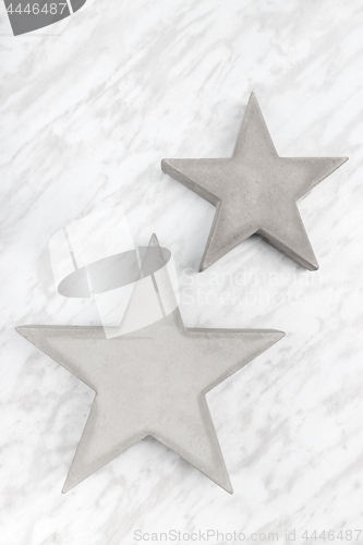 Image of Two concrete stars on marble background