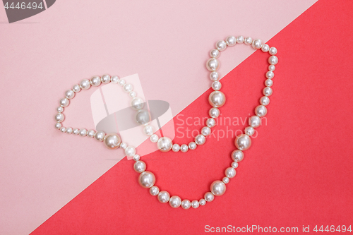 Image of Shiny pearl necklace on pink background