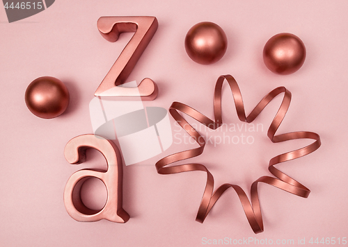 Image of Copper decorative objects on pink background