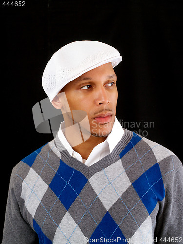 Image of Young black man in sweater and white cap