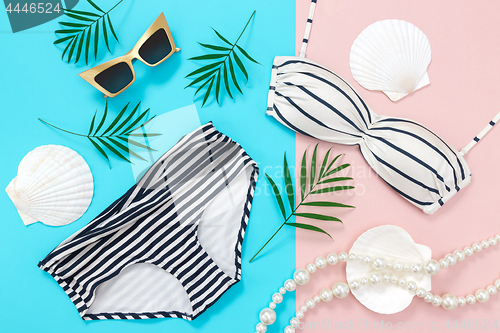 Image of Summer holidays flat lay on blue and pink background