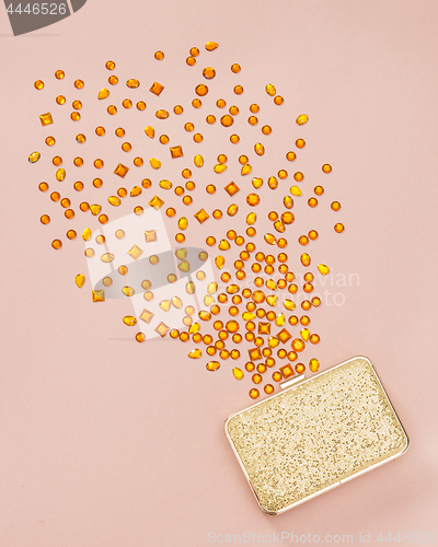 Image of Gemstones spilling out of a golden purse