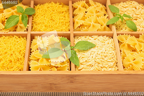 Image of Wooden storage box with different types of pasta