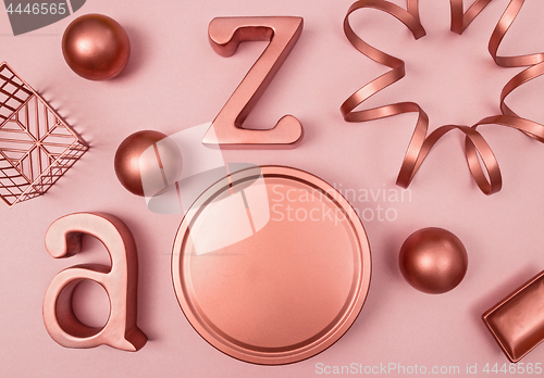 Image of Decorative copper objects on pastel pink background