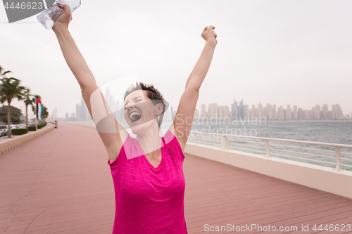 Image of young woman celebrating a successful training run