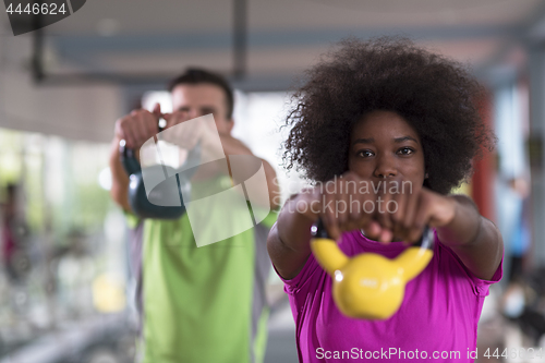 Image of couple  workout with weights at  crossfit gym