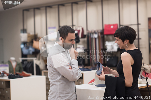 Image of couple chooses shoes At Shoe Store