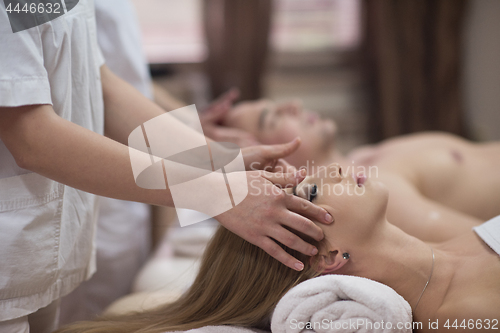 Image of couple enjoying head massage at the spa