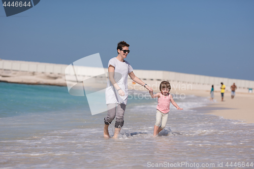 Image of mother and daughter running on the beach