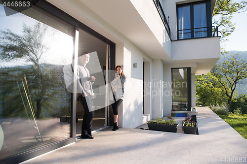 Image of couple enjoying on the door of their luxury home villa