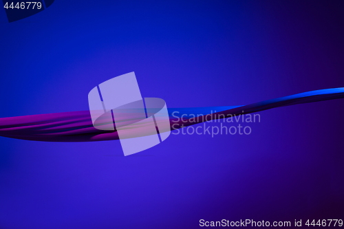 Image of Smooth elegant transparent blue cloth separated on blue background.