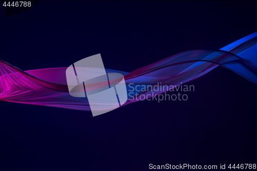 Image of Smooth elegant transparent blue cloth separated on blue background.