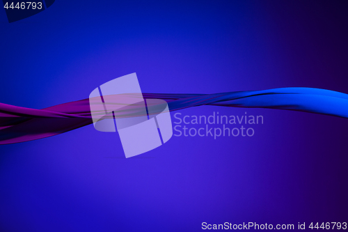 Image of Smooth elegant transparent blue cloth separated on blue background.