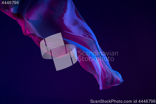 Image of Smooth elegant transparent blue cloth separated on blue background.