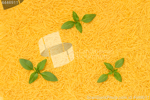 Image of Noodles background decorated with basil leaves