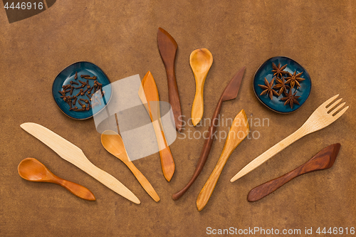 Image of Handcrafted wooden utensils and spices on leather background