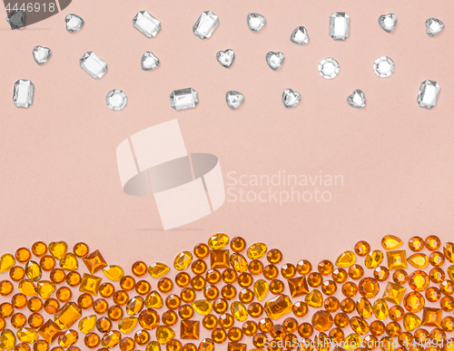 Image of Rhinestones on pastel pink background