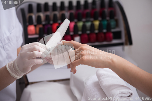 Image of Woman hands receiving a manicure