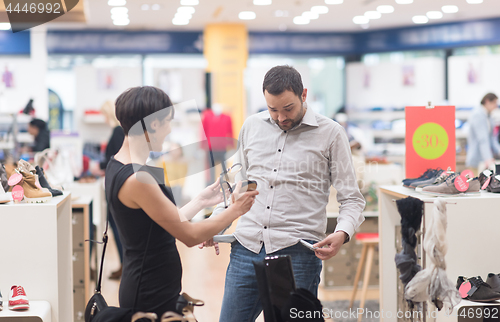 Image of couple chooses shoes At Shoe Store