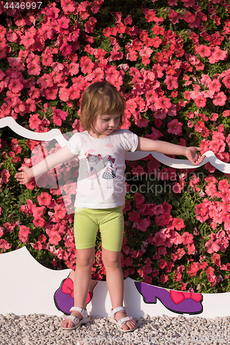 Image of little cute girl in a flower garden