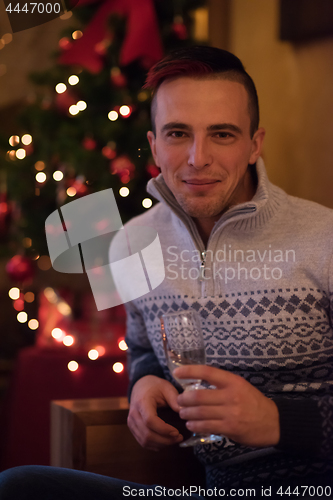 Image of Happy young man with a glass of champagne