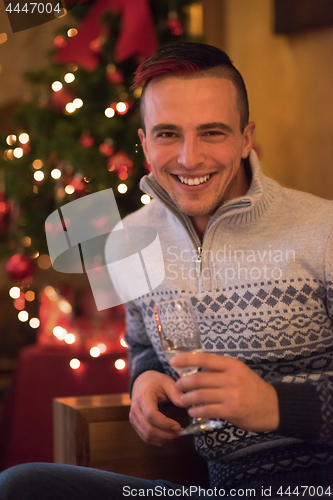 Image of Happy young man with a glass of champagne