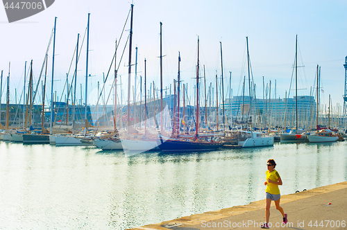 Image of Woman running at marina. Barcelona