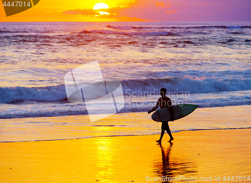 Image of Surfer at sunset. Bali island