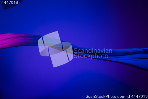 Image of Smooth elegant transparent blue cloth separated on blue background.