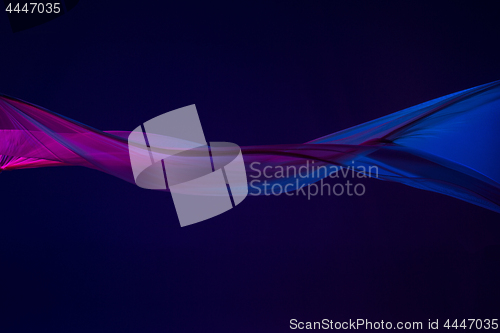 Image of Smooth elegant transparent blue cloth separated on blue background.