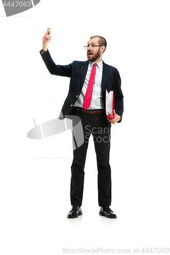 Image of Happy businessman talking on the phone with folder in hand isolated over white background in studio shooting