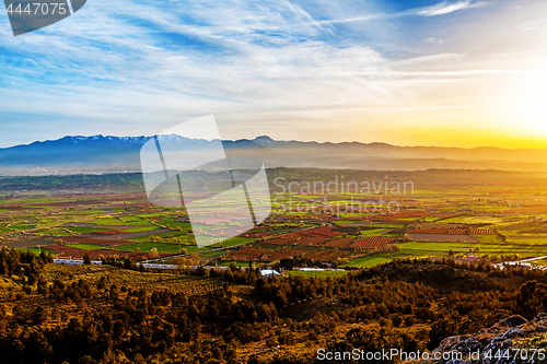 Image of Beutiful sunset over colored agricultiral fields