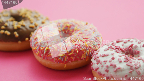 Image of Row of glazed sweet doughnuts