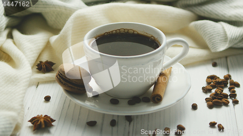 Image of Cup of coffee with spices and macaron