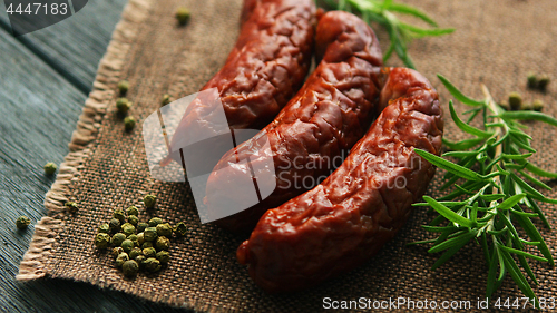 Image of Rosemary and pepper near whole sausages