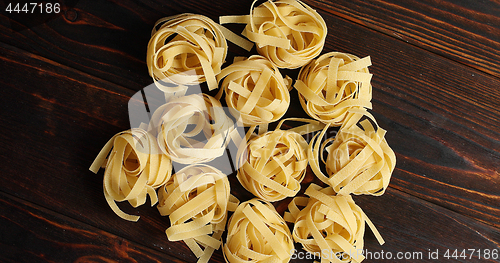 Image of Bunches of raw pasta on table