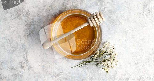 Image of Bowl of honey with spindle