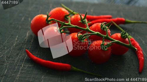 Image of Wet ripe tomatoes and chili pepper