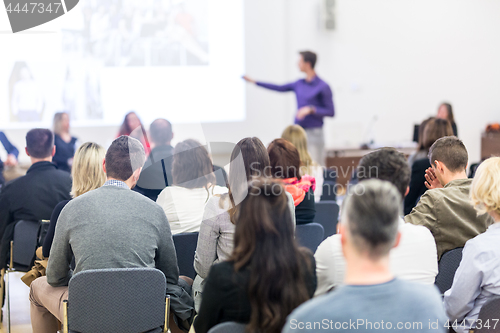 Image of Audience in lecture hall participating at business conference.