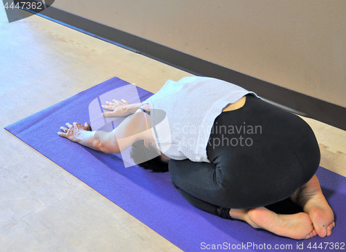 Image of Female doing yoga exercises.